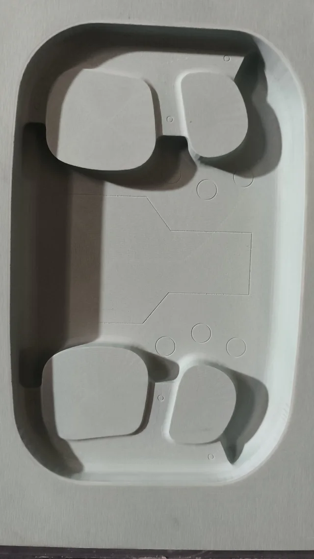 Pieza rectangular con cavidades y relieves redondeados